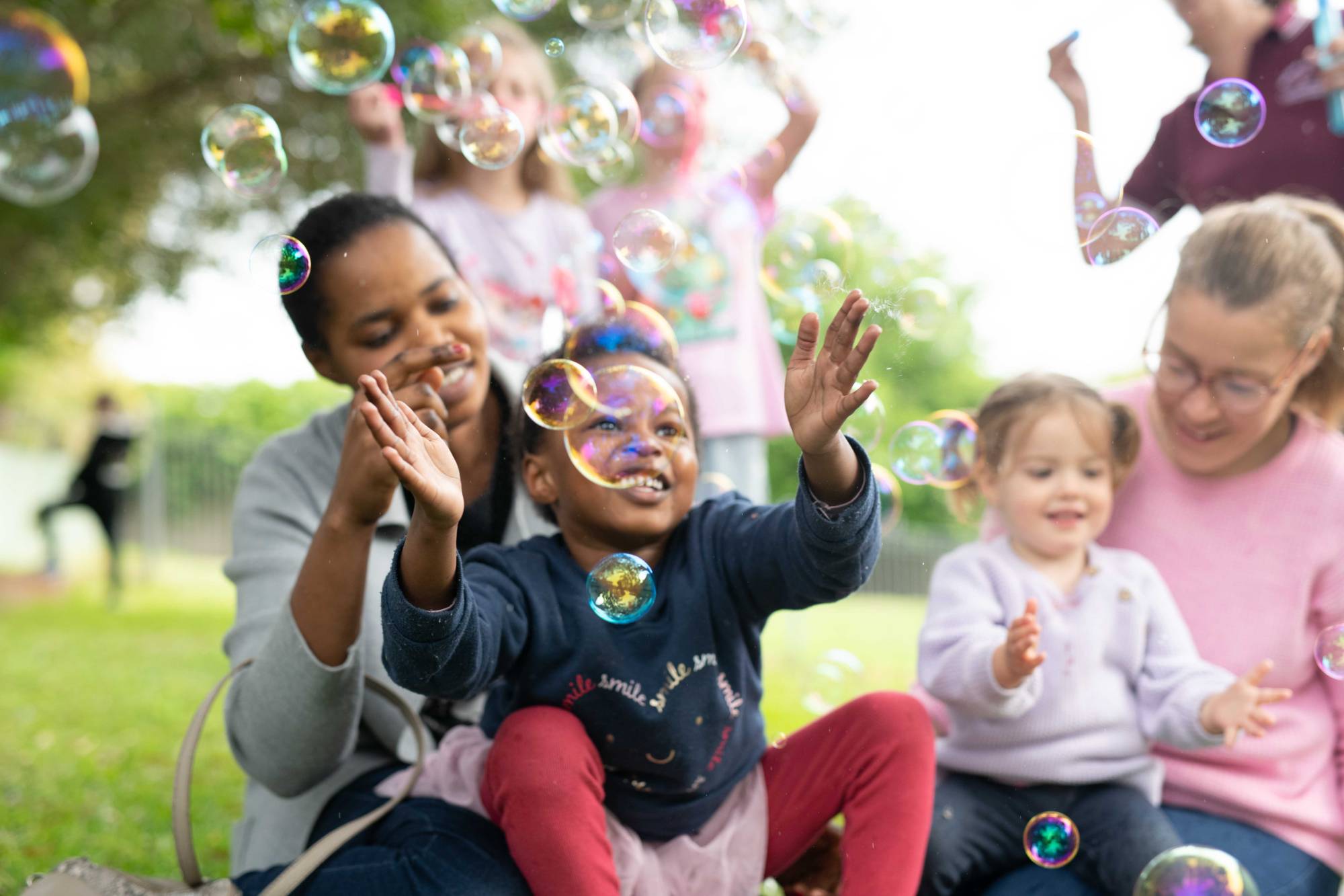 child and mother blowing bubbles